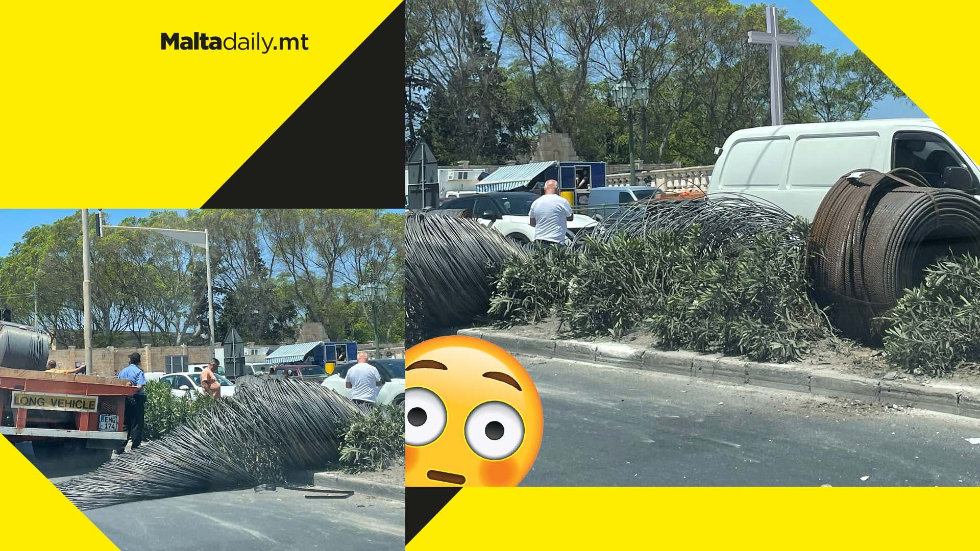 Traffic in Paola after large metal coils fall off truck & into street