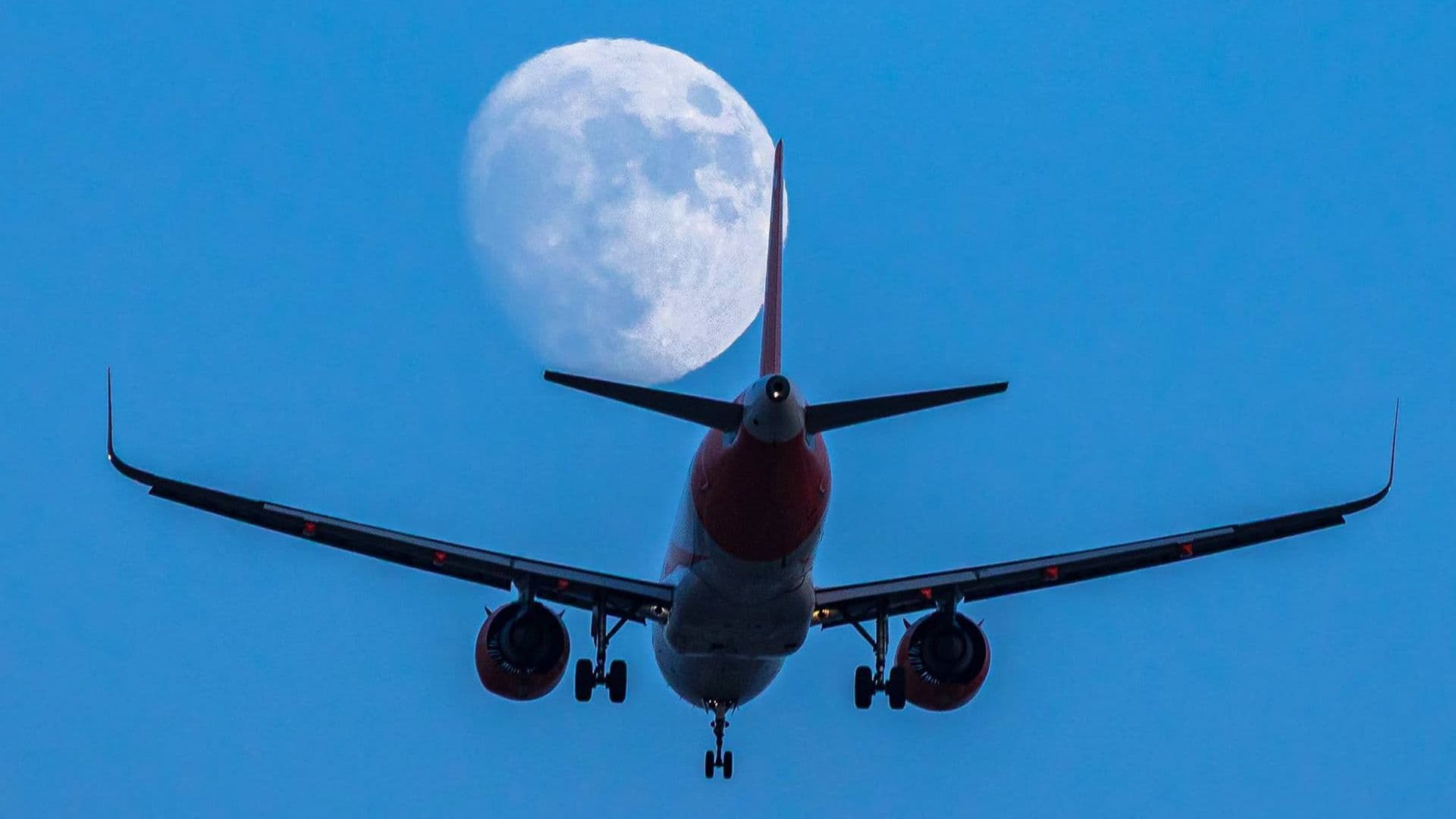 Local Photographer Snaps Striking Shot Of Plan Seemingly Flying Towards The Moon