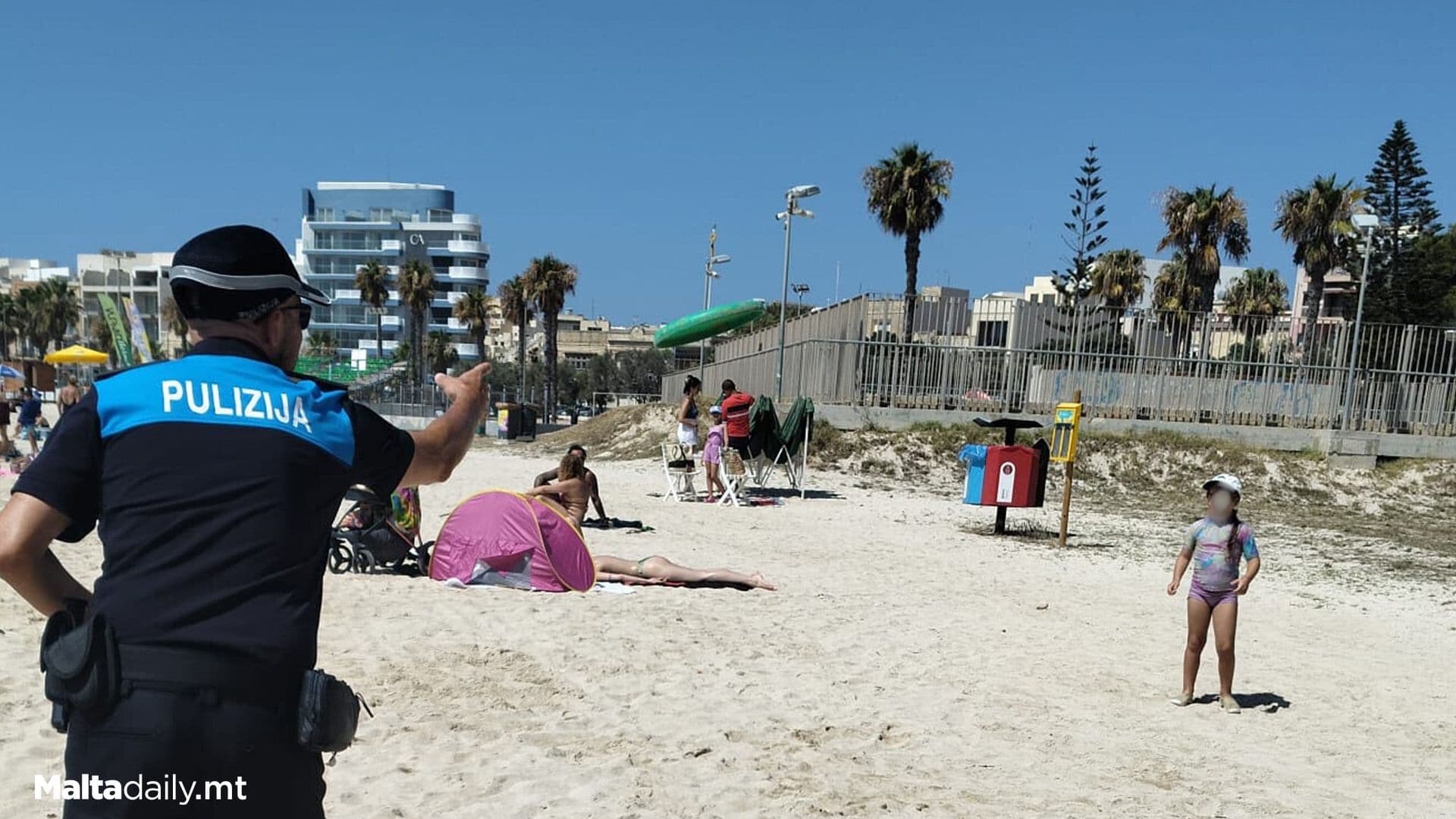 Police Officer Plays Frisbee With Little Beach Goer