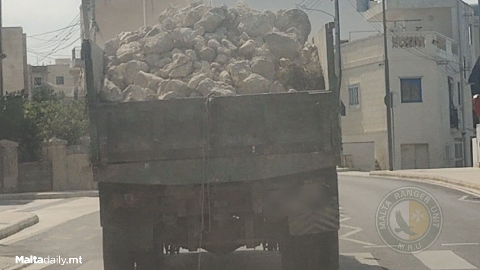 Road Hazard As Truck Carrying Piles Of Rocks Drives Uncovered